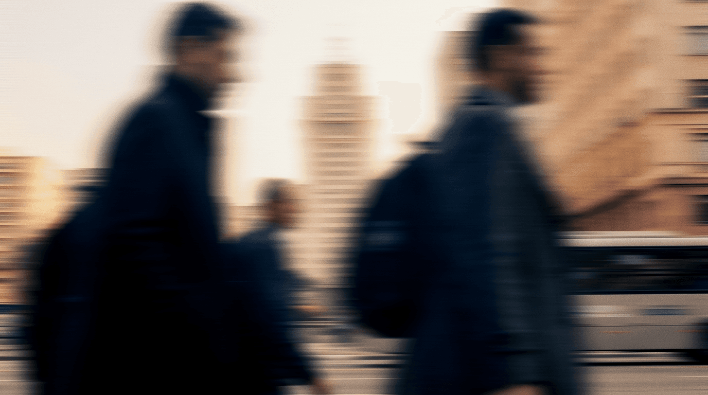 Commuters walking past a São Paulo tower, blurred in motion