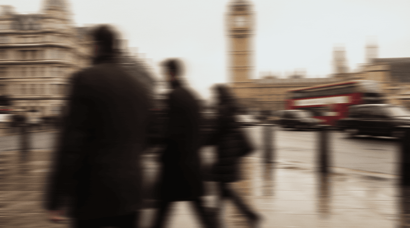 People walking along a London street toward Big Ben, blurred in motion